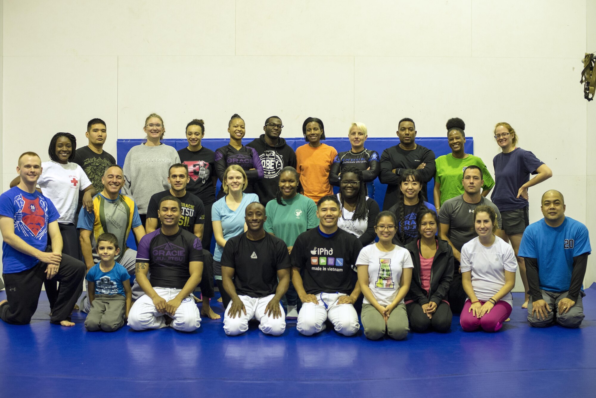 The first students to participate in the Gracie Jiu-Jitsu self-defense course pose for a class photo with instructors at the Samurai Fitness Center 15 Oct. 2016 at Yokota Air Base, Japan. The free self-defense class is available for anyone and is scheduled to start on 18 Oct. 2016 from 5-6 p.m., every Tuesday and Friday for 10 weeks. (U.S. Air Force photo by Airman 1st Class Donald Hudson/Released)