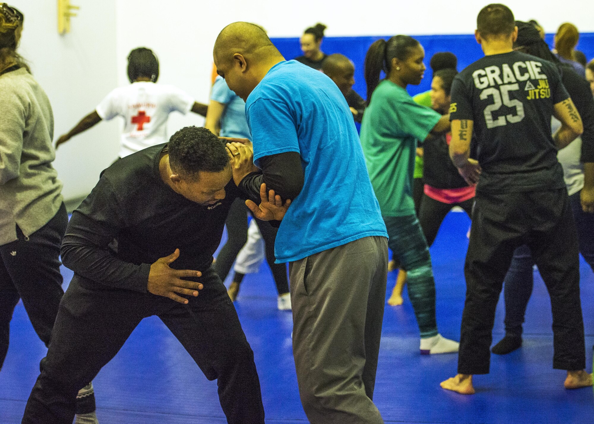 Students practice self-defense positions with each other during a Gracie Jiu-Jitsu class held at the Samurai Fitness Center 15 Oct. 2016 at Yokota Air Base, Japan. The free self-defense class is offered for anyone, no experience is necessary. (U.S. Air Force photo by Airman 1st Class Donald Hudson/Released)