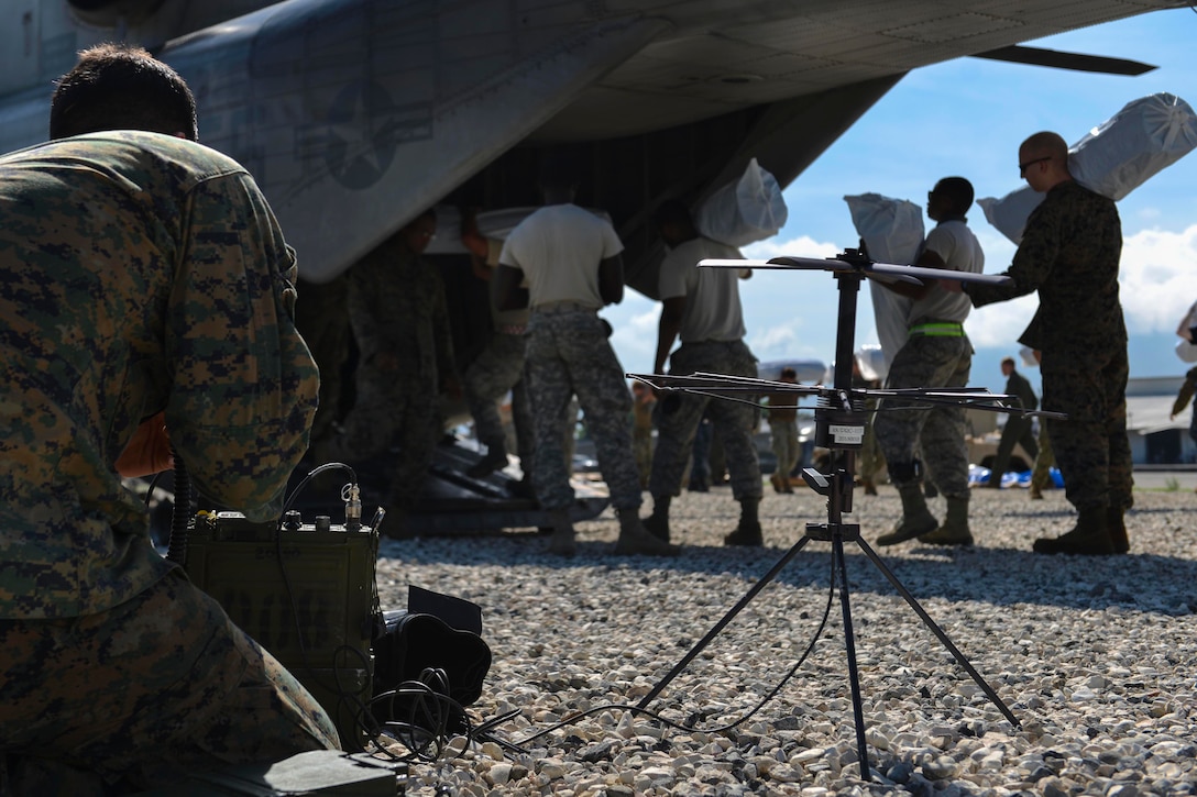 Service members attached to Joint Task Force Matthew off-load supplies for delivery in Port-au-Prince, Haiti, Oct. 17, 2016. JTF Matthew is providing humanitarian aid and disaster relief to Haiti following Hurricane Matthew. Navy photo by Petty Officer 2nd Class Andrew Murray