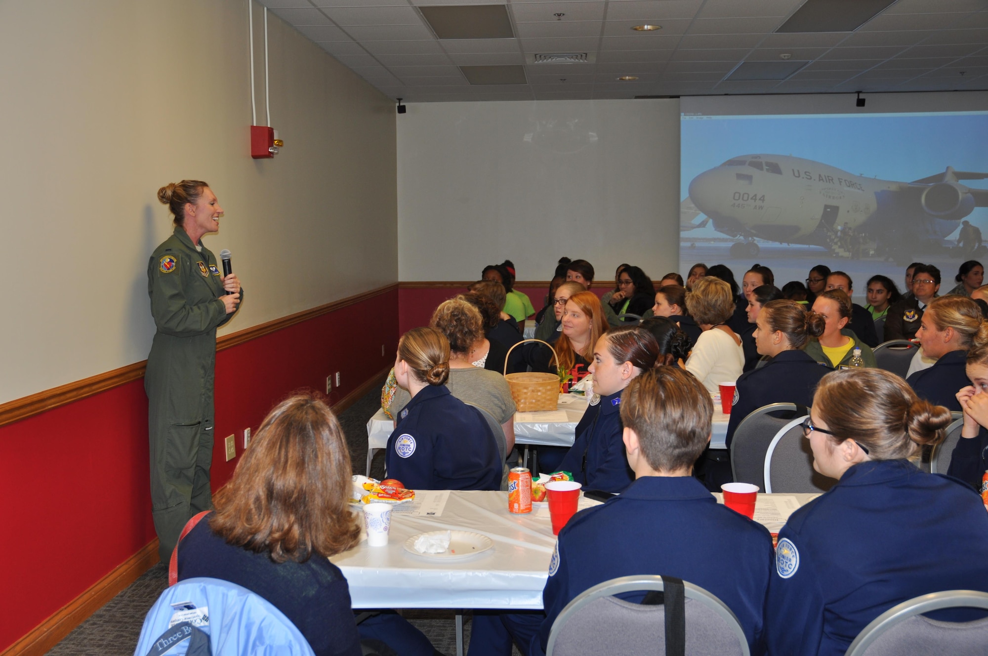 First Lt. Stacey Blurton, 445th Aeromedical Evacuation Squadron flight nurse, talks about her career to more than 90 students attending the Wings of Women Conference Sept. 30, 2016. The students from six local high schools attended the conference and participated in a mentor lunch, C-17 Globemaster III and aeromedical evacuation squadron tours, plus participated in hands-on demonstrations by the security forces, aerospace medicine and civil engineer squadrons (U.S. Air Force photo/Staff Sgt. Rachel Ingram)