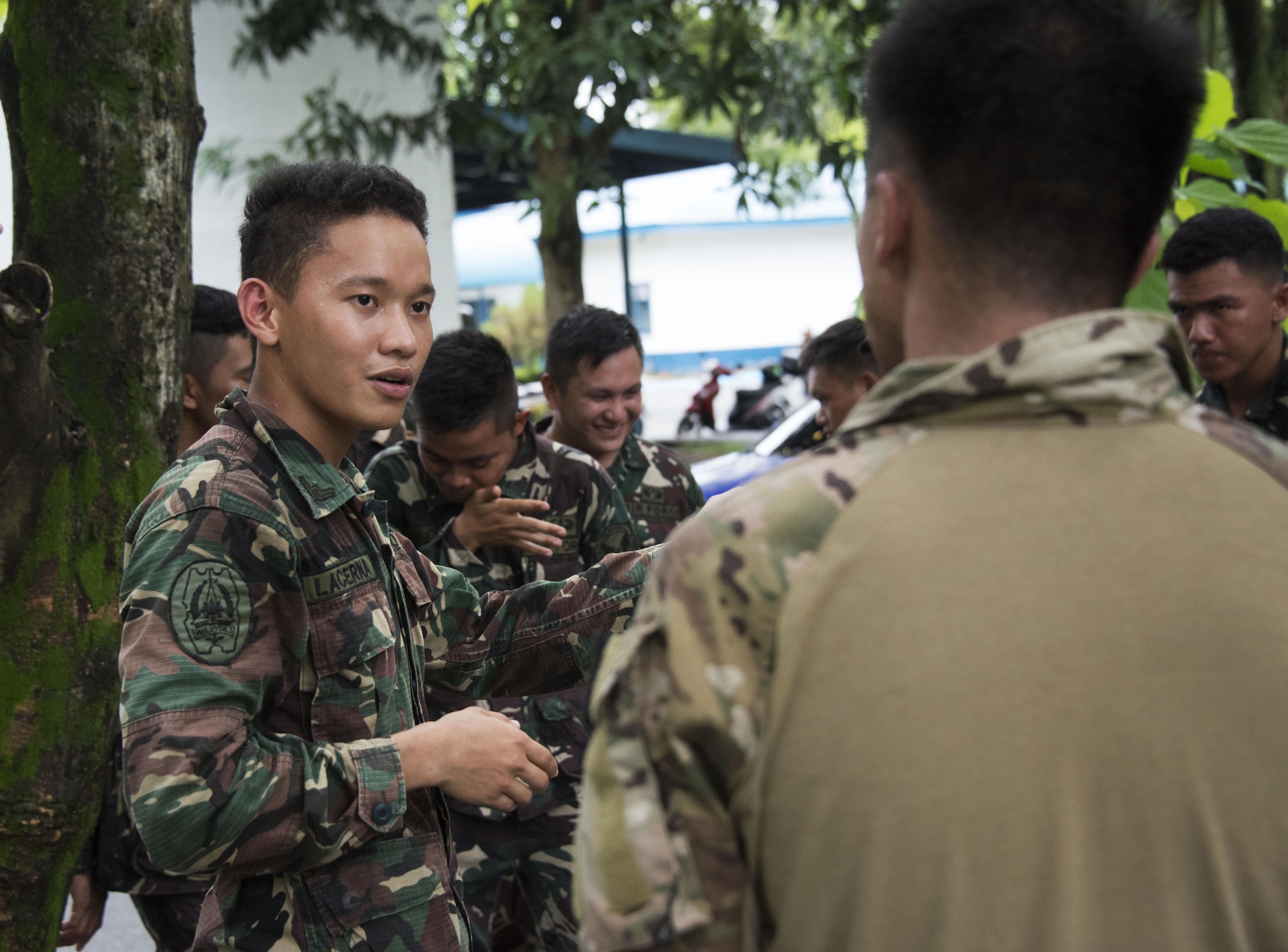 710th Special Operations Wing Airman expresses gratitude to Capt. Caesar Baldemor, Deployed Aircraft Ground Response Element (DAGRE) flight commander and SSgt Steven J. Rock, DAGRE assistant team leader, for the training provided during Teak Piston 2016. From Sept. 15-30, DAGRE team members provided instruction on air base defense theory, command and control structure, entry control point operations, military working dog applications, vehicle operations, law enforcement operations, active shooter response procedures, anti-terrorism, small unit tactics and close quarters battle. (U.S. Air Force photos by Capt. Jessica Tait)
