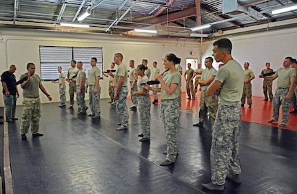 Two U.S. Army military police Soldiers (left) from the 728th MP Battalion, 8th MP Brigade, 8th Theater Sustainment Command demonstrate various baton techniques to U.S. Army reservists with the 414th Military Police Company headquartered in Joplin, Mo., as part of the company’s law enforcement integration and certification training held Sept. 4-28, at Schofield Barracks, Hawaii. (U.S. Army photo by Staff Sgt. Taresha Hill, 8th Military Police Brigade Public Affairs, 8th Theater Sustainment Command)