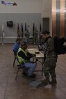 A Soldier assigned to the 785th MP Bn., is weighed at the Silas L. Copeland Arrival/Departure Airfield Control Group here Oct. 3.