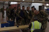 Soldiers assigned to the 305th Engineer Facility Detachment and the 785th Military Police Battalion, both Army Reserve units, are weighed, manifested and processed prior to boarding a flight to the U.S. Central Command at the Silas L. Copeland Arrival/Departure Airfield Control Group here Oct. 3. Photos by Ismael Ortega, Mobilization and Deployment, DPTMS Public Affairs.
