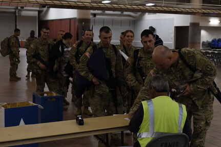 Soldiers assigned to the 305th Engineer Facility Detachment and the 785th Military Police Battalion, both Army Reserve units, are weighed, manifested and processed prior to boarding a flight to the U.S. Central Command at the Silas L. Copeland Arrival/Departure Airfield Control Group here Oct. 3. Photos by Ismael Ortega, Mobilization and Deployment, DPTMS Public Affairs.