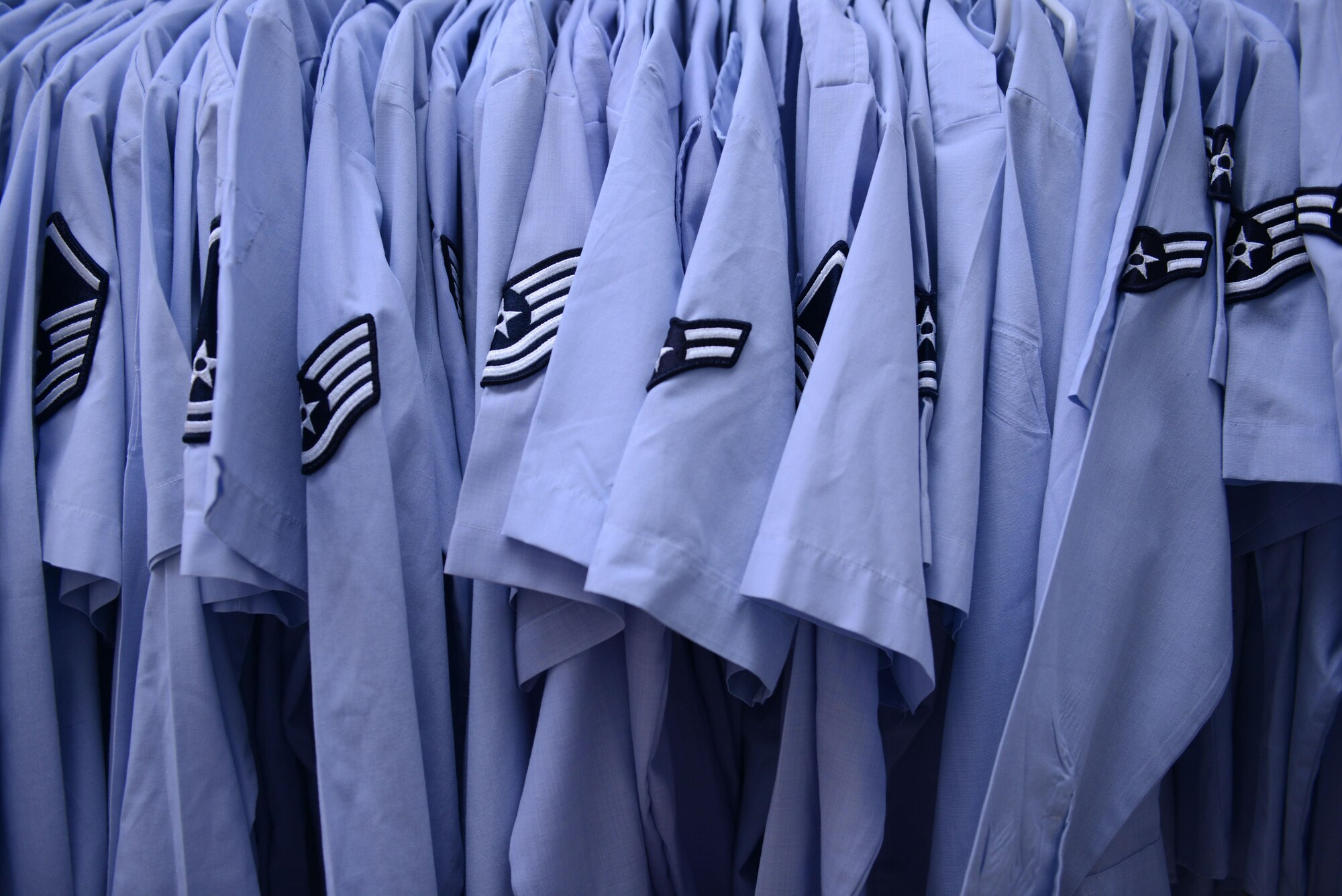 Several Air Force blues shirts are displayed in the Airman’s Attic at Aviano Air Base, Italy on Oct. 19, 2016. The Airman’s Attic supports military members E-5 and below and their family members with a variety of household goods and clothing items with the exception of uniform items which are available for all ranks. (U.S. Air Force photo by Staff Sgt. Andrew M. Satran/Released)