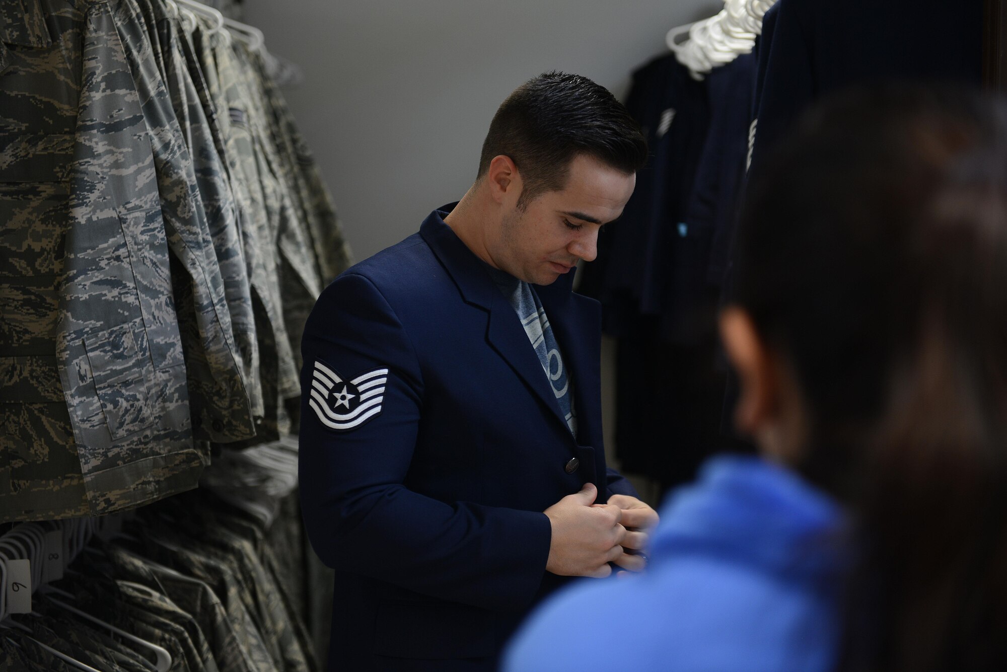 Staff Sgt. Eric Newell, 31st Maintenance Squadron aircraft fuels system repair technician, tries on a uniform item during the Airman’s Attic reopening at Aviano Air Base, Italy on Oct. 19, 2016. The Airman’s Attic supports military members E-5 and below and their family members with a variety of household goods and clothing items with the exception of uniform items which are available for all ranks. (U.S. Air Force photo by Staff Sgt. Andrew M. Satran/Released)