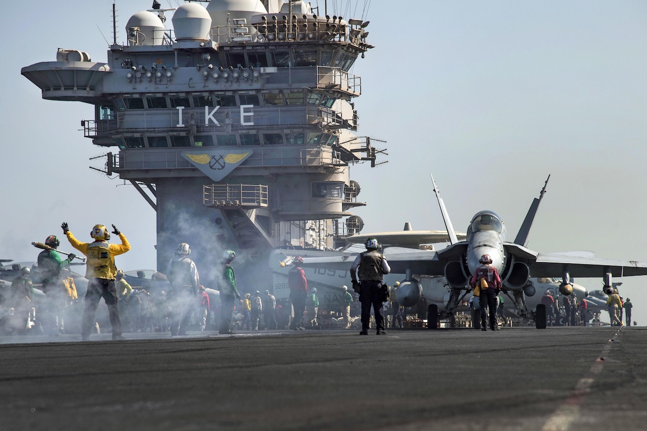 An F/A-18C Hornet aircraft taxis toward a bow catapult on the flight deck of the aircraft carrier USS Dwight D. Eisenhower in the Persian Gulf, Oct. 16, 2016. The pilots and aircraft are assigned to Strike Fighter Squadron 131. The Eisenhower and its Carrier Strike Group are deployed in support of Operation Inherent Resolve, maritime security operations and theater security cooperation efforts in the U.S. 5th Fleet area of operations. Navy photo by Seaman Christopher A. Michaels