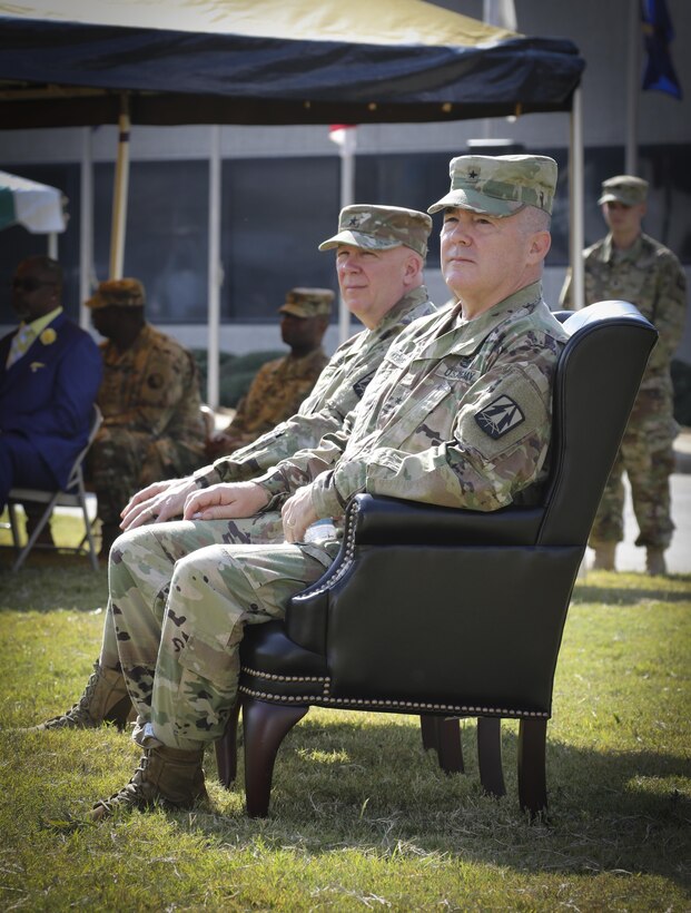 Brig. Gen. Christopher R. Kemp (front right), former commander of the 335th Signal Command (Theater), and Brig. Gen. (Promotable) Peter A. Bosse, incoming commander for the 335th SC (T), listen to comments by Maj. Gen. David J. Conboy, deputy commanding general (operational), United States Army Reserve Command during a change of command ceremony at Fort McPherson, Georgia Oct. 15.