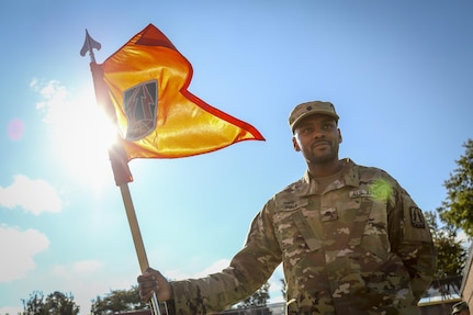 U.S. Army Spc. Rodney Pina, a motor pool supply specialist from Boston, Mass., holds the 335th Signal Command (Theater) guidon for an end-of-day formation at the 335th headquarters in East Point, Ga., Oct. 16, 2016. (U.S. Army photo by Staff Sgt. Ken Scar)