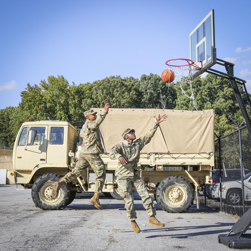 Two soldiers with the 335th Signal Command (Theater) play some hoops in the motor pool at the 335th headquarters in East Point, Ga., Oct. 16, 2016. (U.S. Army photo by Staff Sgt. Ken Scar)