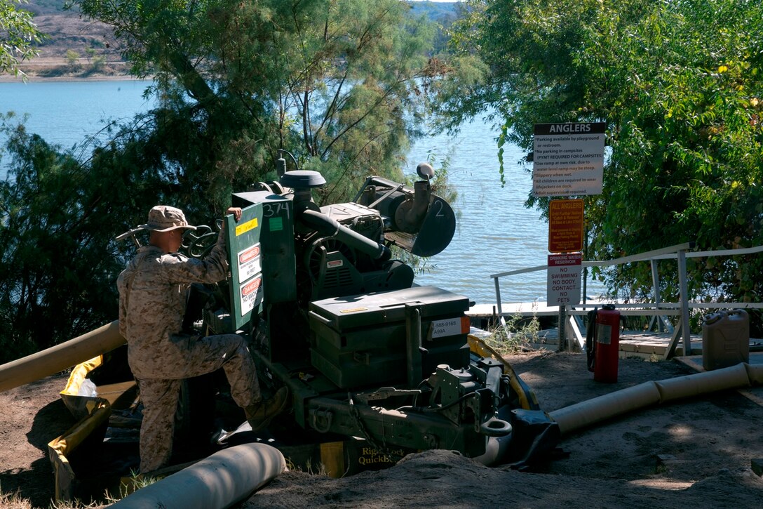 U.S. Marine Corps Pfc. Silas Thomas, from Colebrook, Ohio, a bulk fuel specialist with Bulk Fuel Company, 7th Engineer Support Battalion, inspects one of the 600-gallon-per-minute pumps while it draws water from Lake O’Neill to take to the 200,000 gallon storage site during the bulk fuel Marine Corps Combat Readiness Evaluation on Camp Pendleton, Calif., Oct. 12, 2016. By using water from Lake O’Neill, the Marines were able to simulate the process of pumping fuel from ship to shore in an expeditionary environment.