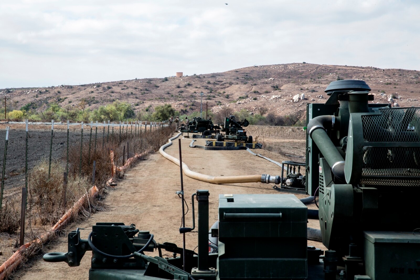 Four 600-gallon-per-minute pumps standby ready to pump water into one of the 50,000 gallon bags at the storage site during the bulk fuel Marine Corps Combat Readiness Evaluation on Camp Pendleton, Calif., Oct. 12, 2016. By using water from Lake O’Neill, the Marines were able to simulate the process of pumping fuel from ship to shore in an expeditionary environment.