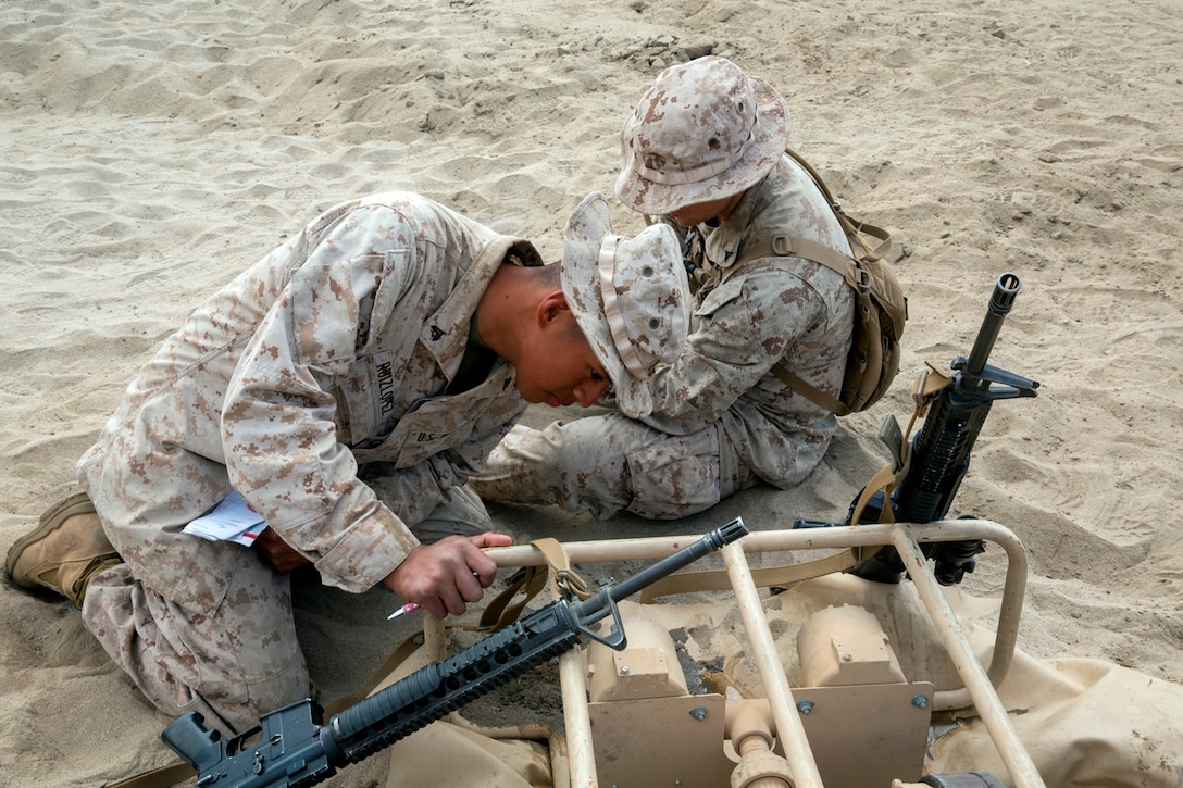 U.S. Marine Corps Cpl. Samuel Ruizlopez, from Aberdeen, Washington, and Lance Cpl. Brian Iza Cortes, from Madison, New Jersey, both bulk fuel specialists with Bulk Fuel Company, 7th Engineer Support Battalion, work together to record the flow of water through a 6-inch hose reel system during the bulk fuel Marine Corps Combat Readiness Evaluation on Camp Pendleton, Calif., Oct. 12, 2016. To record the flow water, they use a meter that tells how many gallons of water has been processed through that section of the hose so Marines can know exactly how much water has passed through.