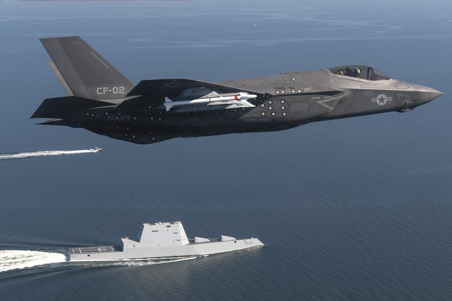 An F-35 Lightning II flies over the USS Zumwalt in the Chesapeake Bay.