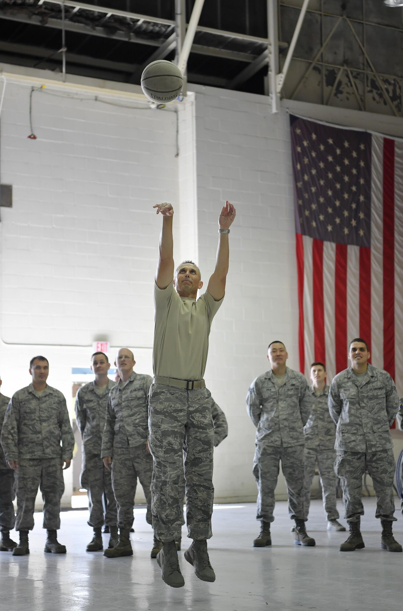 Chief Master Sgt. Todd Petzel, 18th AF command chief, takes a “jumper from downtown” while playing horse with Airmen from the 305th Operations Support Squadron at the squadron’s Air Traffic Control, Approach and Landing System building Oct. 12. Petzel and Lt. Gen. Sam Cox, 18th Air Force commander, learned about the unique deployable capabilities of the ATCALS system during their visit to JB McGuire-Dix-Lakehurst. (U.S. Air Force photo by Christian DeLuca/released)