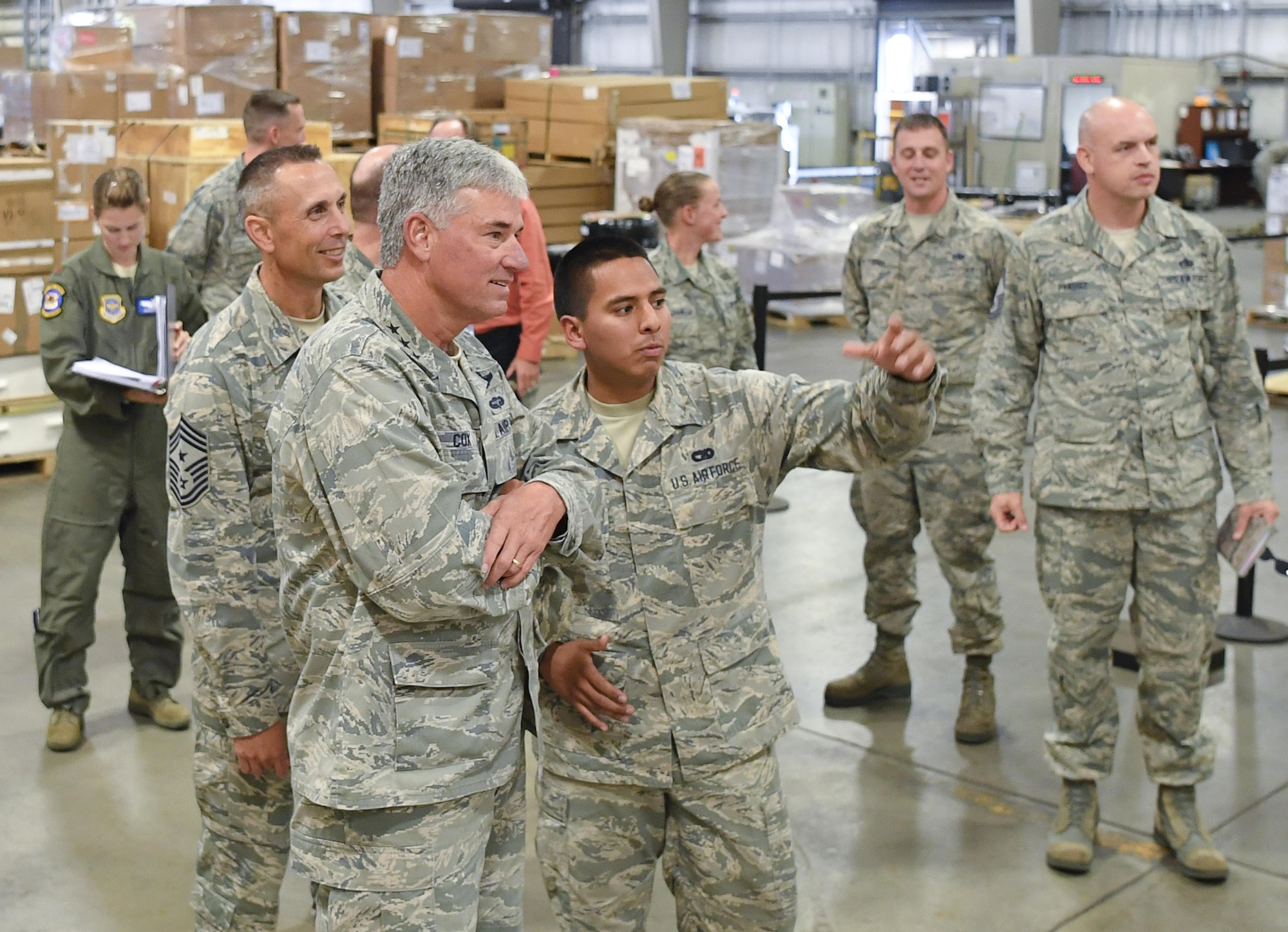 Airman 1st Class Christopher Pacheco, 305th Aerial Port Squadron, shows Lt. Gen. Sam Cox, 18th Air Force commander, and Chief Master Sgt. Todd Petzel, 18th AF command chief, around the squadron’s freight terminal Oct. 12. The squadron recently received the 2016 Verne Orr Award for its ability to effectively use available resources to accomplish their mission. During the award period, the 305th APS moved 78,000 tons of cargo, airlifted more than 190,000 passengers and launched 99 percent of 9,000 airlift missions on-time. (U.S. Air Force photo by Christian DeLuca/released)