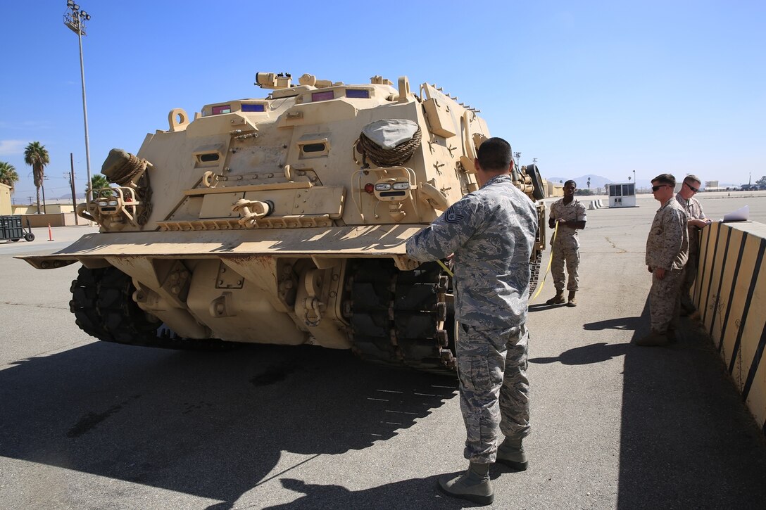 U.S. Marines and Airmen conduct a joint-inspection of an M-88A2 HERCULES at March Air Force Reserve Base, Calif., Oct. 13, 2016. The inspection is to ensure that the vehicle can safely be flown on the C-17 Globemaster III  to Marine Corps Air Ground Combat Center Twentynine Palms, Calif. In the joint-inspection Marines and Airmen check the center of balance, hazardous material and cleanliness of the vehicle.