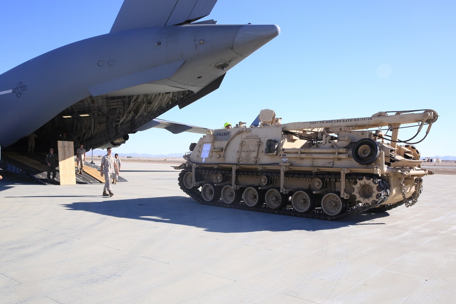 U.S. Marines and Airmen unload the M-88A2 HERCULES at Marine Corps Air Ground Combat Center Twentynine Palms, Calif., Oct. 14, 2016. Transporting the M-88A2 from March Air Force Reserves Base, Calif., to Combat Logistics Company 13 in Twentynine Palms, helped the aircrew for the C-17 Globemaster III meet quarterly requirements.
