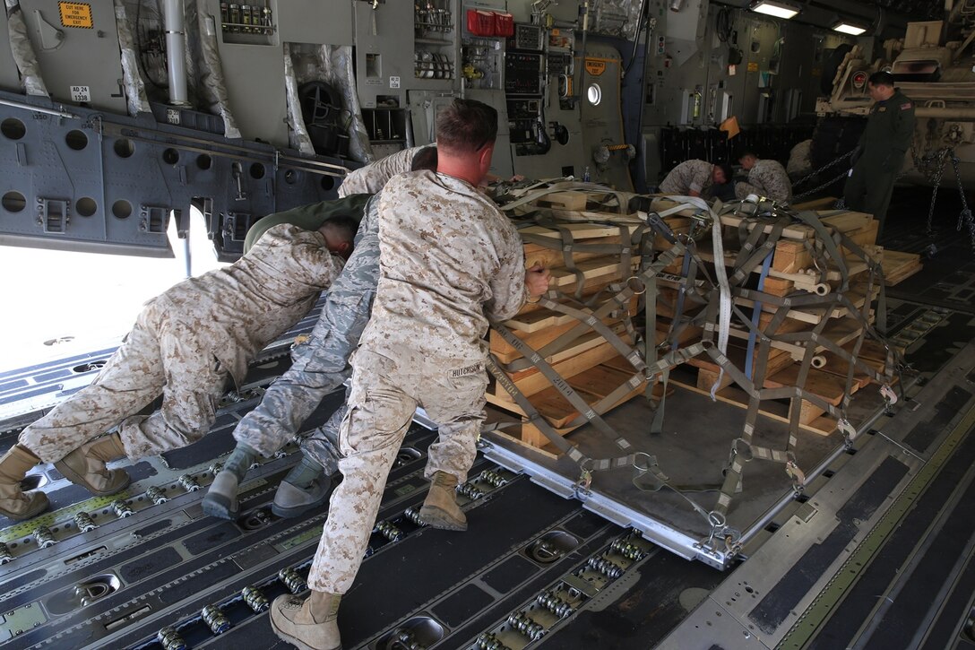 U.S. Marines and Airmen work hand-in-hand to load a pallet, filled with an M-88A2 HERCULES’ armored side skirts and front winch aboard the C-17 Globemaster III at March Air Force Reserves Base, Calif., Oct. 14, 2016. The C-17 flew to Marine Corps Air Ground Combat Center Twentynine Palms, Calif., to deliver the M-88A2 recovery vehicle for use by Combat Logistics Company 13.