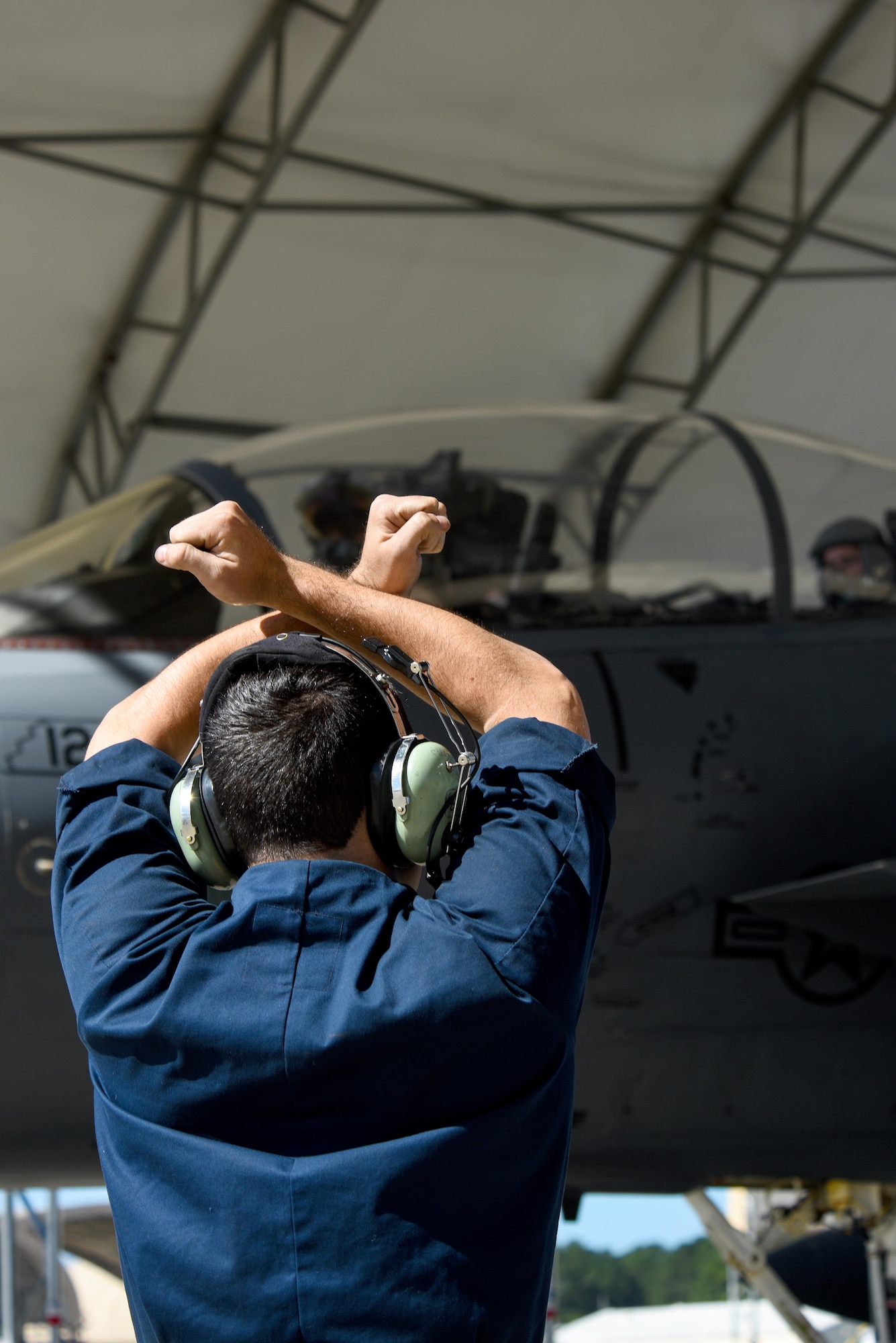 An Airman from the 4th Aircraft Maintenance Squadron marshals in an F-15E Strike Eagle assigned to the 335th Fighter Squadron as it returns from deployment, Oct. 12, 2016, at Seymour Johnson Air Force Base, North Carolina. More than 25 members of the 335th Fighter Squadron returned from an undisclosed location in Southeast Asia and were greeted by friends and family upon arrival. (U.S. Air Force photo by Airman Shawna L. Keyes)