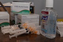 Vaccination needles lay on a table during a vaccination exercise at Minot Air Force Base, N.D., Oct. 13, 2016. The 5th Medical Group conducted a base-wide exercise to efficiently provide vaccinations to the entire base.  (U.S. Air Force photo/Airman 1st Class Jessica Weissman)