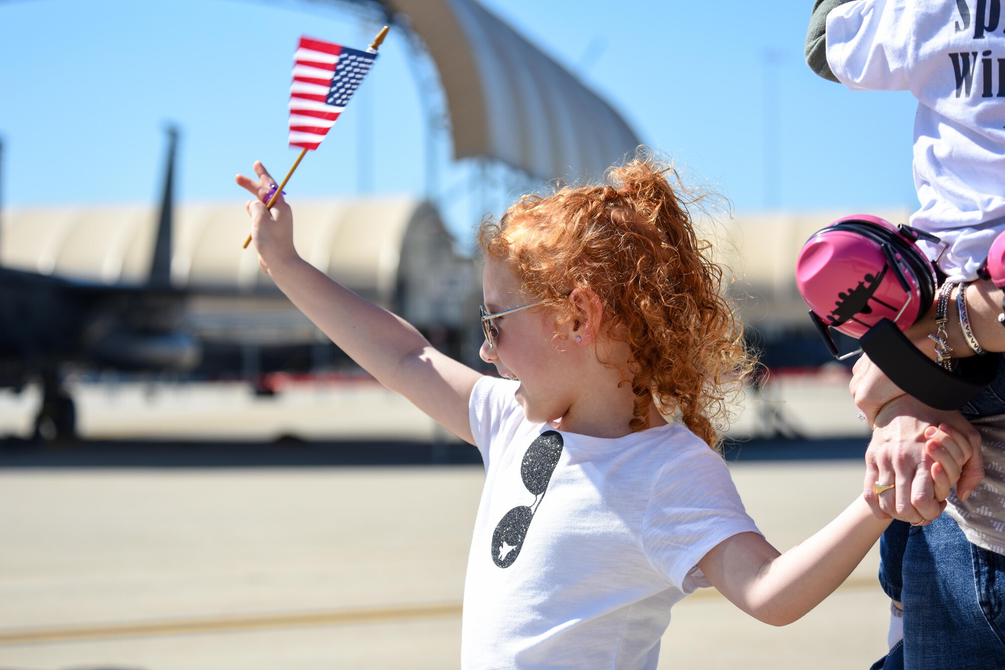 A member of Team Seymour waves to aircrew as they return from deployment, Oct. 12, 2016, at Seymour Johnson Air Force Base, North Carolina. More than 25 members of the aircrew assigned to the 335th Fighter Squadron returned late in the week. (U.S. Air Force photo by Airman Shawna L. Keyes)