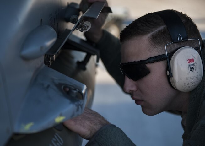 An Airman checks munitions during the third quarter load competition at Nellis Air Force Base, Nev., Oct. 07, 2016. Crews are inspected on their dress and appearance, orderliness of their tool boxes, the weapons load, and a written test to determine the 57th Maintenance Group’s best weapons load crew of the quarter. (U.S. Air Force photo by Airman 1st Class Kevin Tanenbaum/Released)