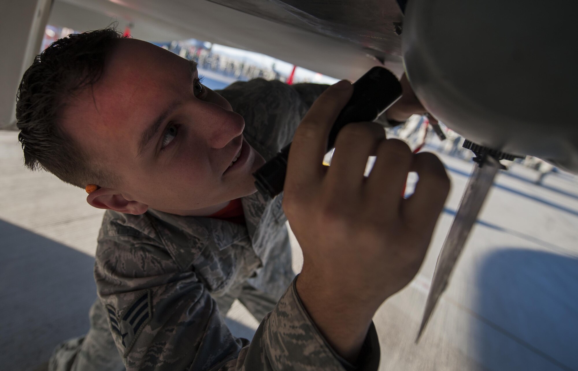 Senior Airman Jake Taeschler, 57th Maintenance Group, evaluates the loading of an F-15 Eagle during the quarterly weapons load competition at Nellis Air Force Base, Nev., Oct. 07, 2016. In addition to recognizing superior performers, load crew competitions also help keep weapons loaders’ skills sharp and ready for real-world situations. (U.S. Air Force photo by Airman 1st Class Kevin Tanenbaum/Released)