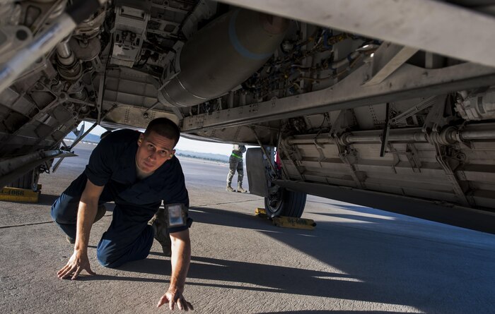 An Airman assigned to the Raptor Aircraft Maintenance Unit checks a loaded munition on an F-22 Raptor during the 57th Wing’s third quarter weapons load crew competition at Nellis Air Force Base, Nev., Oct. 7. The quarterly competition highlights Airmen for their loading skill and duty performance.(U.S. Air Force photo by Airman 1st Class Kevin Tanenbaum/Released)