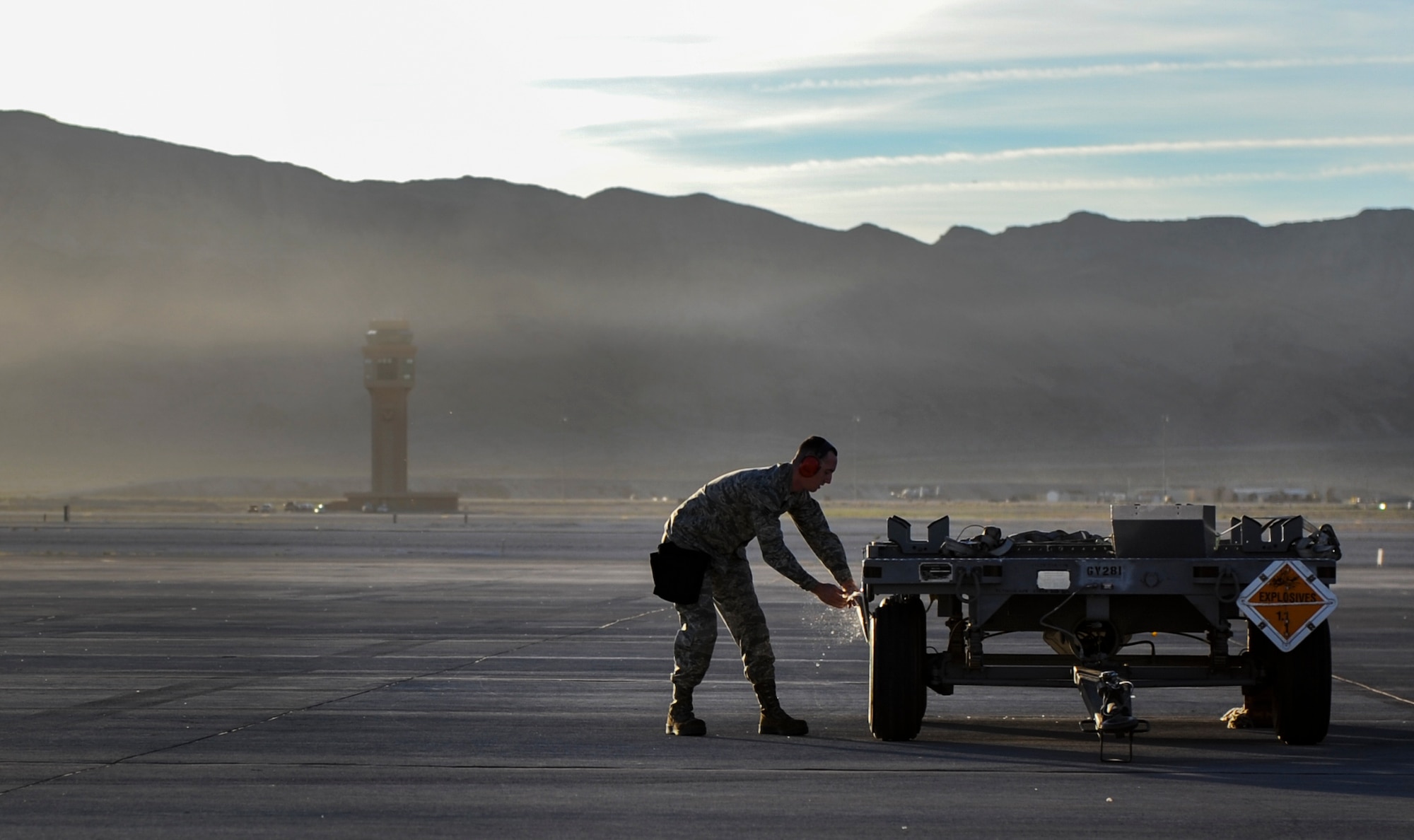 An Airman from the 757th Aircraft Maintenance Squadron secures a weapons cart during the 57th Wing’s third quarter weapons load crew competition at Nellis Air Force Base, Nev., Oct. 7. During the competition, load crew members are evaluated on a written test, dress and appearance inspection, composite tool kit  inspection, and the weapons load. (U.S. Air Force photo by Airman 1st Class Kevin Tanenbaum/Released)