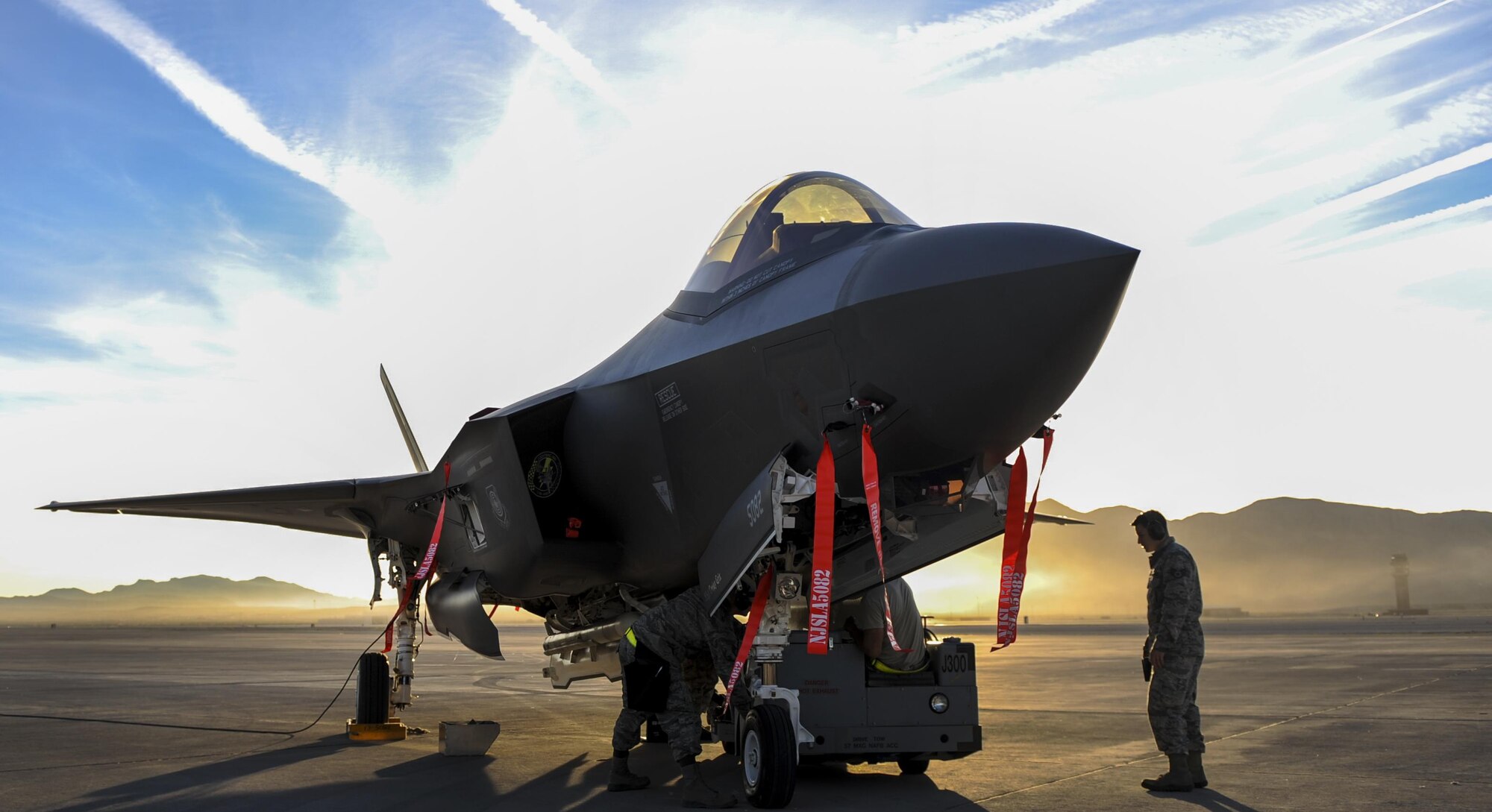 Airmen from the 57th Maintenance Group, Lightning Aircraft Maintenance Unit, load an F-35A Lightning II during the 57th Wing’s third quarter weapons load crew competition at Nellis
Air Force Base, Nev., Oct. 7. Lightning AMU is responsible
for the aircraft maintenance of the F-35A Lightning
II at Nellis AFB. (U.S. Air Force photo by Airman 1st Class Kevin Tanenbaum/Released)