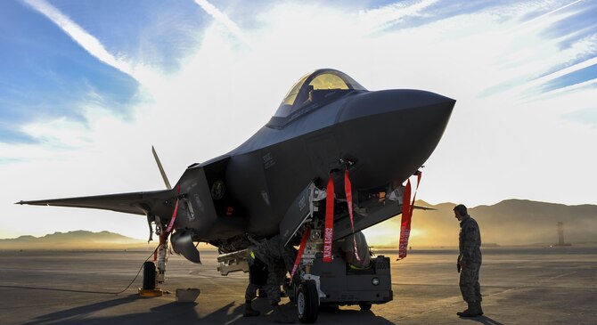 Airmen from the 57th Maintenance Group, Lightning Aircraft Maintenance Unit, load an F-35A Lightning II during the 57th Wing’s third quarter weapons load crew competition at Nellis
Air Force Base, Nev., Oct. 7. Lightning AMU is responsible
for the aircraft maintenance of the F-35A Lightning
II at Nellis AFB. (U.S. Air Force photo by Airman 1st Class Kevin Tanenbaum/Released)