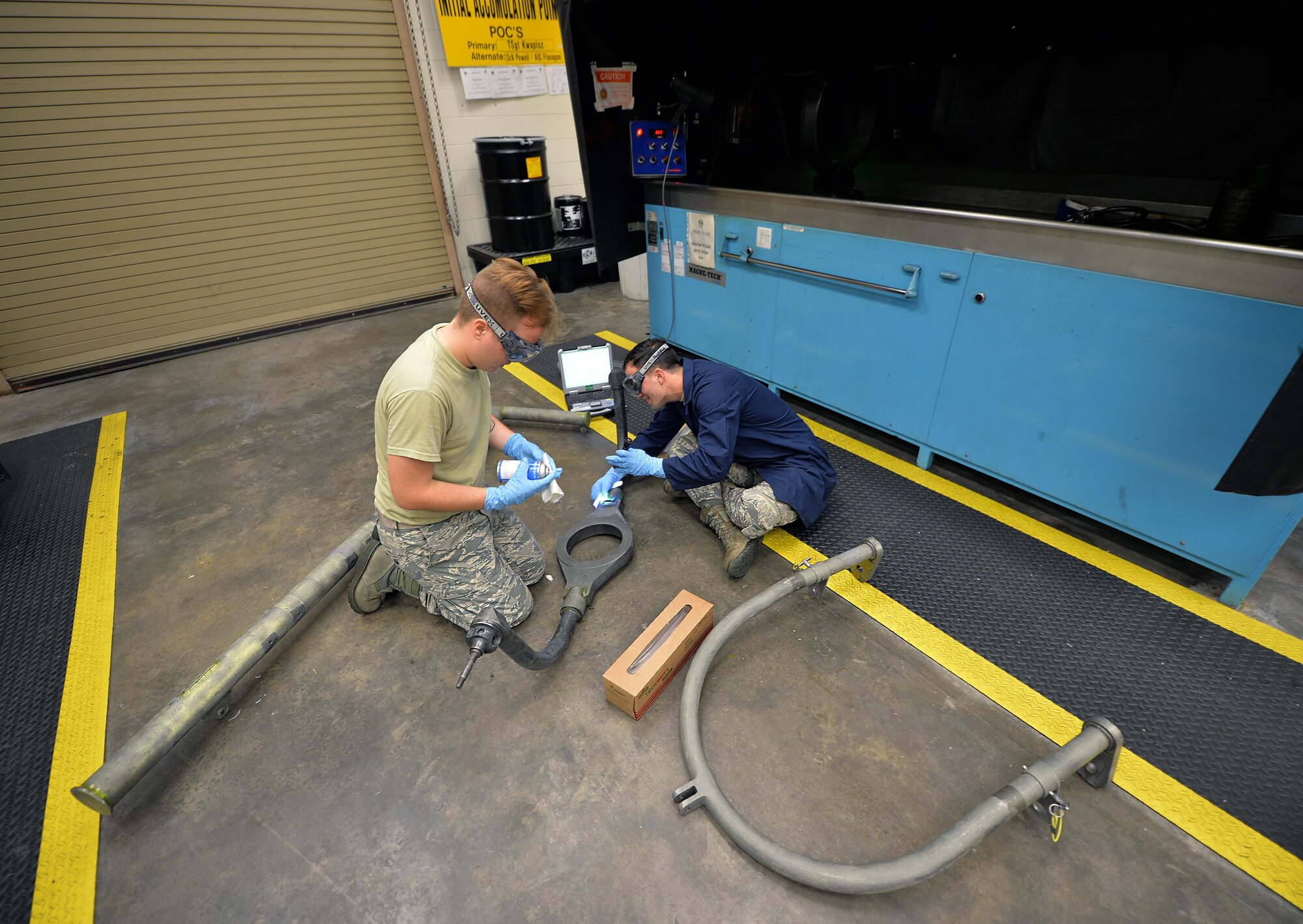 Airman 1st Class Brian Sheldon, a non-destructive inspection journeyman with the 1st Special Operations Maintenance Squadron, stands with a magnetic particle unit at Hurlburt Field Fla., Oct. 17, 2016. A magnetic particle unit blocks light from hitting the prop rod allowing the florescent light to glow indicating imperfections on parts. These specialist use noninvasive methods to inspect the insides of metal objects to identify possible defects in systems and equipment. (U.S. Air Force photo by Senior Airman Andrea Posey)