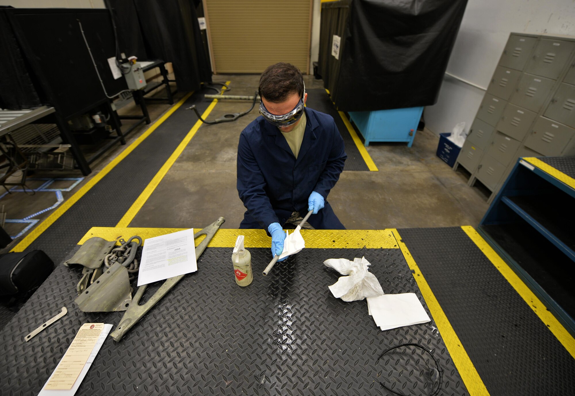 Airman 1st Class Brian Sheldon, a non-destructive inspection journeyman with the 1st Special Operations Maintenance Squadron, stands with a magnetic particle unit at Hurlburt Field Fla., Oct. 17, 2016. A magnetic particle unit blocks light from hitting the prop rod allowing the florescent light to glow indicating imperfections on parts. These specialist use noninvasive methods to inspect the insides of metal objects to identify possible defects in systems and equipment. (U.S. Air Force photo by Senior Airman Andrea Posey)
