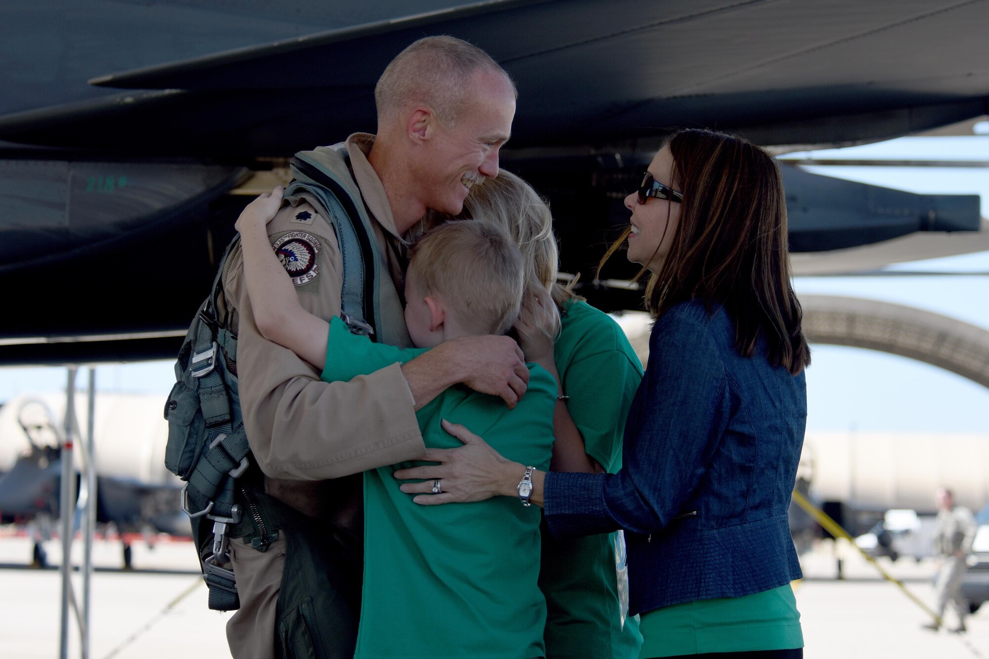 Lt. Col. Brandon Johnson, 335th Fighter Squadron commander, greets his family after returning from a deployment, Oct. 12, 2016, at Seymour Johnson Air Force Base, North Carolina. Johnson was deployed to an undisclosed location in Southwest Asia in support of OPERATION INHERENT RESOLVE.  