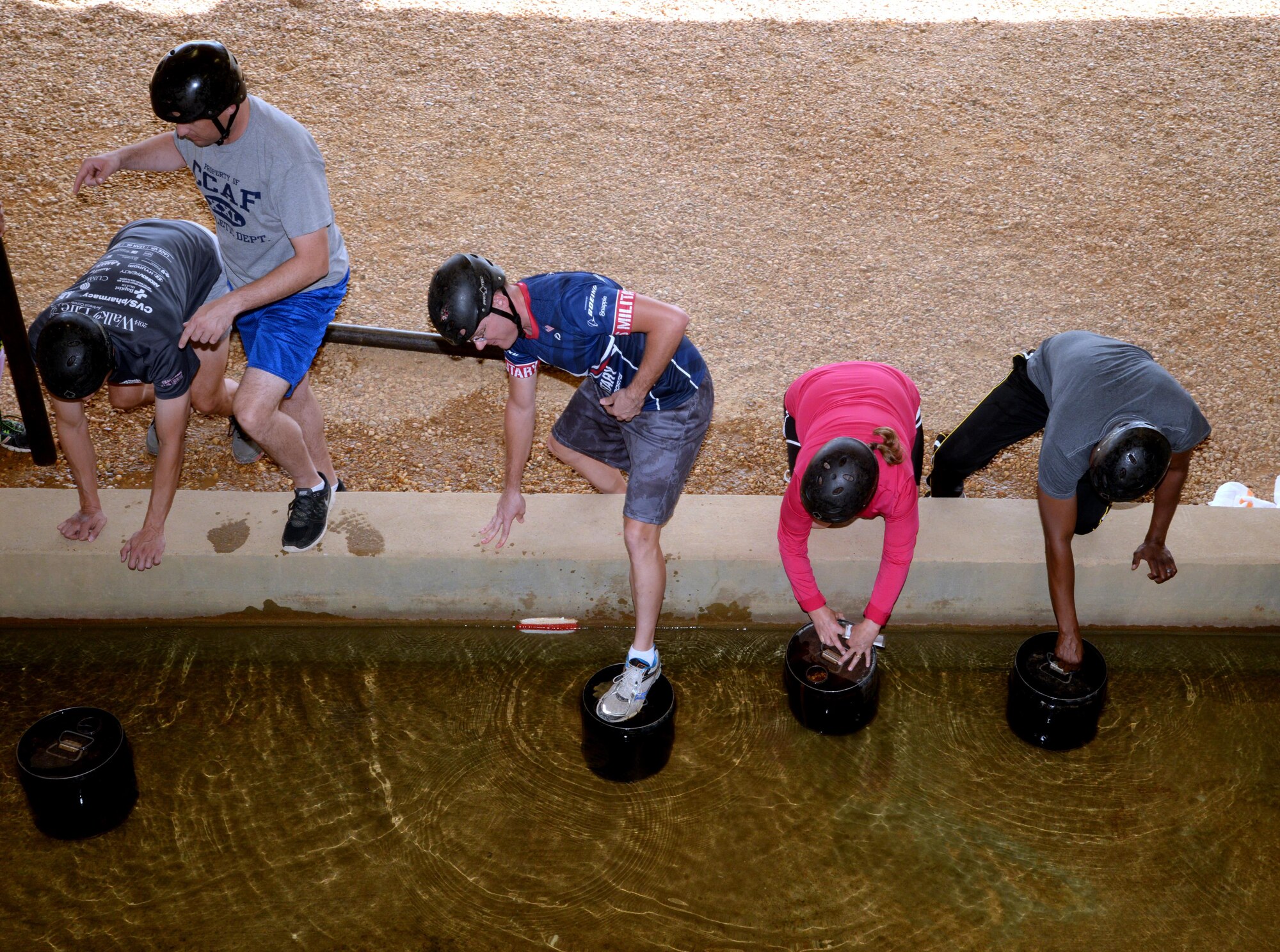 Senior non-commissioned officers prepare to cross an obstacle course within Air University's Project X during the SNCO Professional Development Offsite event, Oct. 14, 2016, Maxwell Air Force Base, Ala. Project X requires teammates to work together and communicate effectively in order to cross the obstacle successfully. (U.S. Air Force photo/ Senior Airman Alexa Culbert)