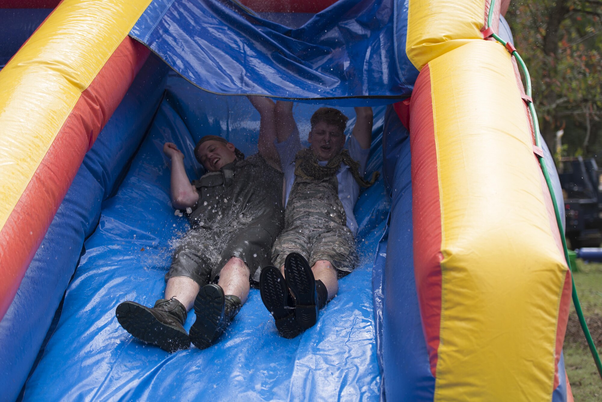 Senior Airman Travis Hahn-Holmes, 85th Engineering Installation Squadron cable and antenna maintainer, and Staff Sgt. Brendon Wright, 85th EIS airfield systems project manager, participate in the running of the “Grog” obstacle course during the 85th EIS Combat Dining-In at the 85th EIS compound Oct 7, 2016, on Keesler Air Force Base, Miss. The combat dining-in is a military tradition which promotes good fellowship and esprit de corps throughout the unit. (U.S. Air Force photo by Andre’ Askew/Released)