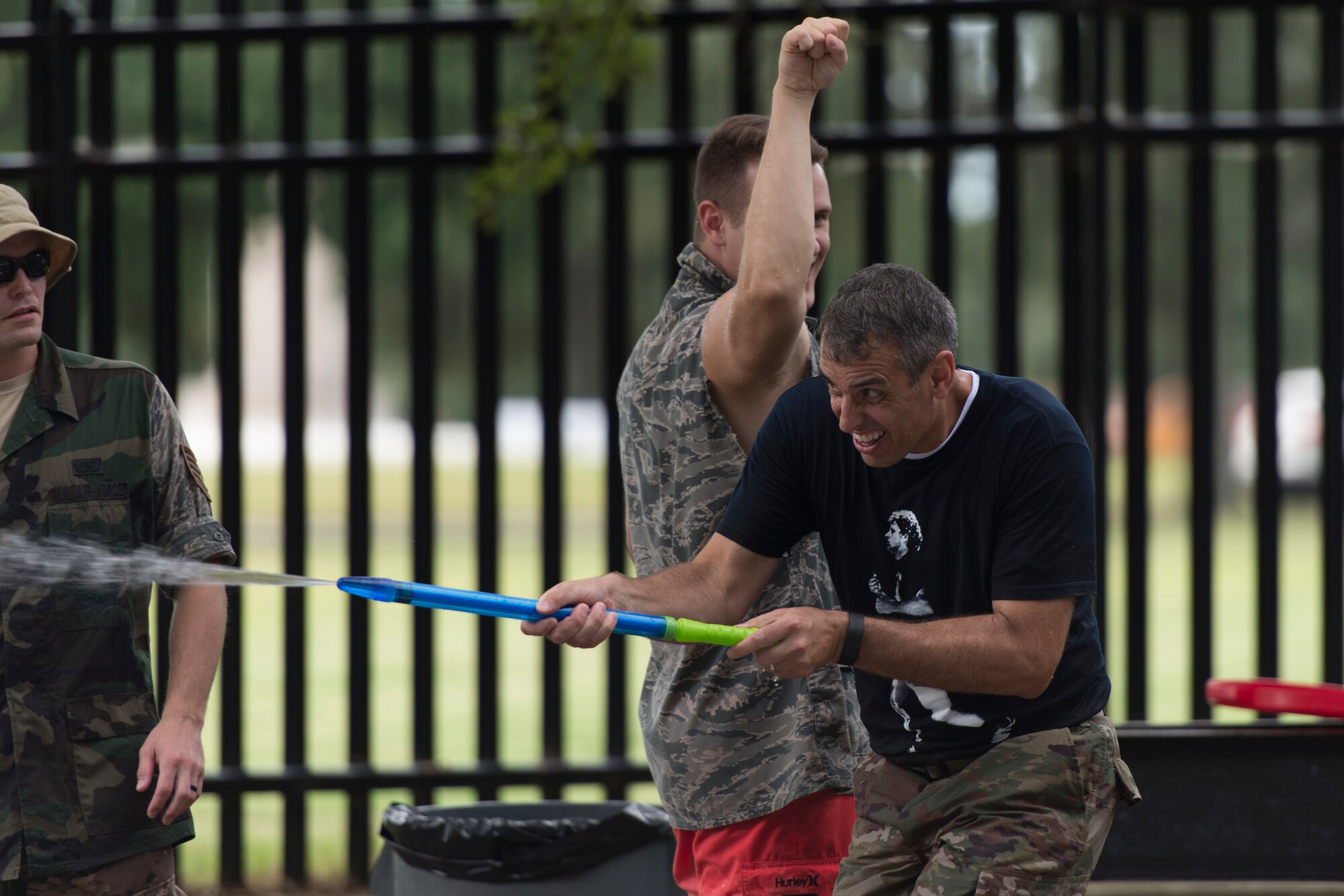 Col. Stan Diamanti, 38th Cyberspace Engineering Installation Group commander, Tinker Air Force Base, Okla., participates in a super soaker battle with 85th Engineering Installation Squadron members during the 85th EIS Combat Dining-In at the 85th EIS compound Oct 7, 2016, on Keesler Air Force Base, Miss. The combat dining-in is a military tradition which promotes good fellowship and esprit de corps throughout the unit. (U.S. Air Force photo by Andre’ Askew/Released)
