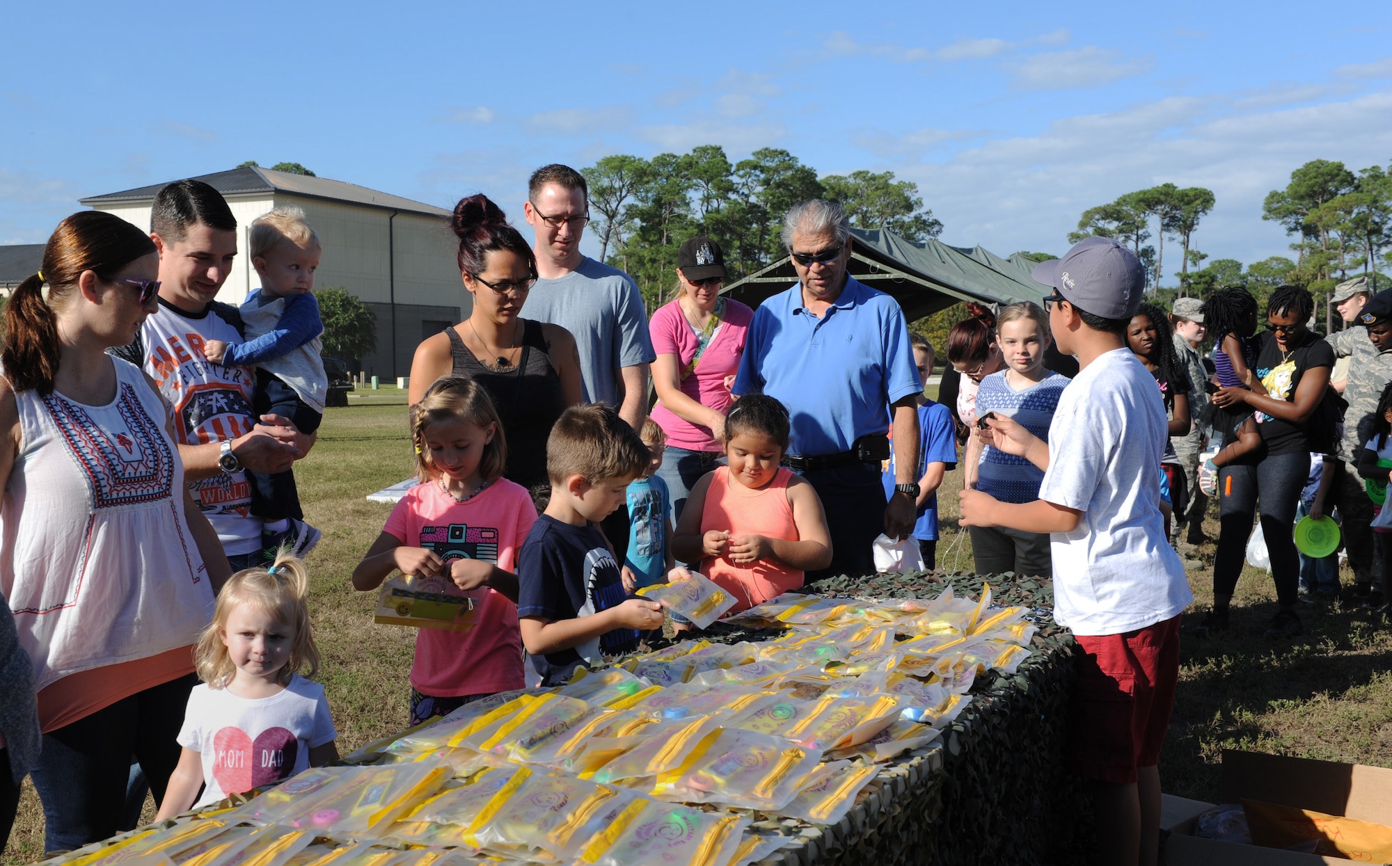Keesler families process through a deployment line during Operation Hero Oct. 15, 2016, on Keesler Air Force Base, Miss. The event was designed to help children better understand what their parents do when they deploy. (U.S. Air Force photo by Kemberly Groue/Released)