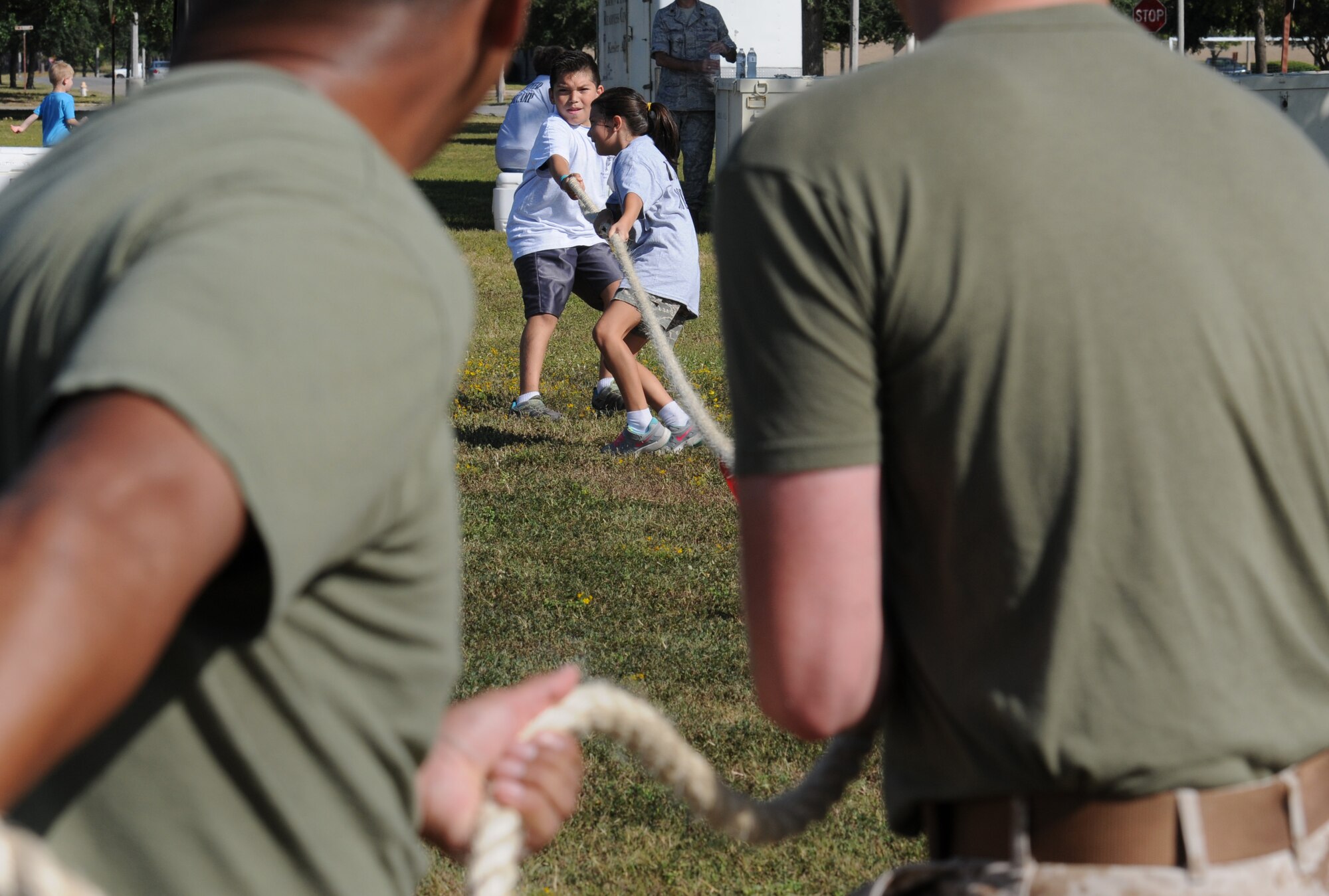Andrew and Bella Stevenson, children of Tech. Sgt. Soledad Stevenson, 81st Force Support Squadron readiness NCO in charge, participate in tug-of-war with Keesler Marine Detachment students , during Operation Hero Oct. 15, 2016, on Keesler Air Force Base, Miss. The event was designed to help children better understand what their parents do when they deploy. (U.S. Air Force photo by Kemberly Groue/Released)