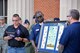 Maj. Stan Grodrian, left, Gathering of Eagles Foundation president and ACSC student, reads a citation during a gift presentation Oct. 13th at Auburn University.  Students and faculty from ACSC traveled to Auburn University’s AFROTC detachment to participate in the detachment’s career day.  After talking with cadets about career opportunities in the Air Force, the Gathering of Eagles Foundation presented the detachment with a lithograph of previous Eagles who made lasting contributions to air power.  (US Air Force photo by Maj. Will Powell)