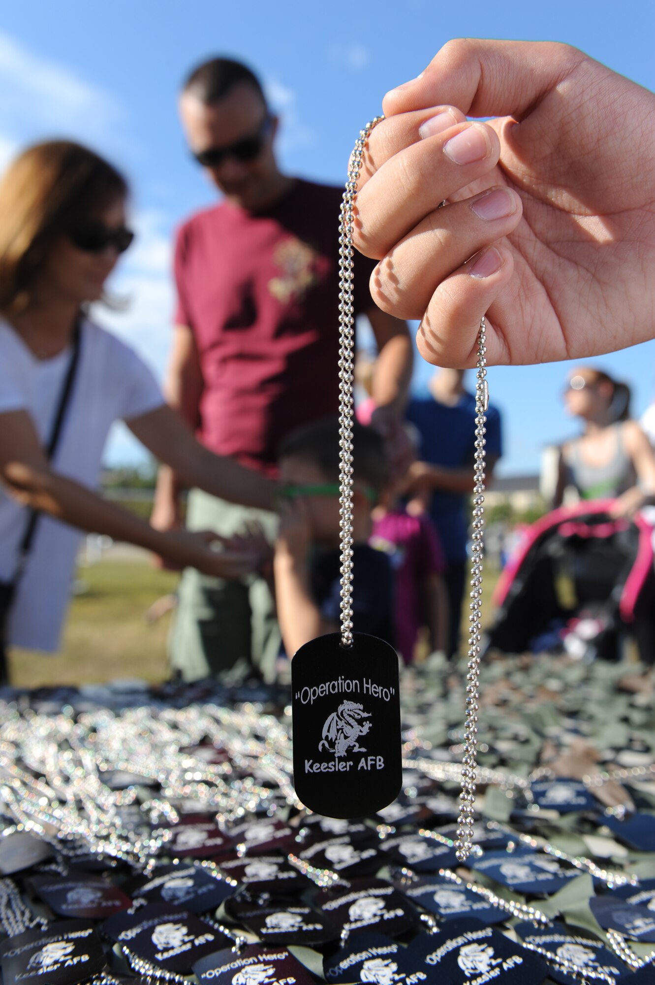 Ruben Cerda, Jr., son of Ruben Cerda, 81st Force Support Squadron airman and family services flight chief, holds a dog tag during Operation Hero Oct. 15, 2016, on Keesler Air Force Base, Miss. The event was designed to help children better understand what their parents do when they deploy. (U.S. Air Force photo by Kemberly Groue/Released)