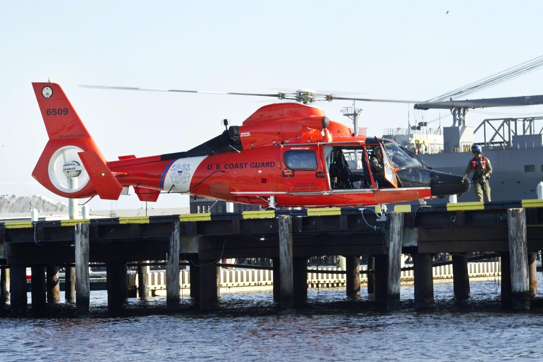 A Coast Guard crew assigned to Air Station Atlantic City, N.J., prepares their HH-65C Dolphin helicopter for departure after taking part in an air show during Maryland Fleet Week in Baltimore, Oct. 16, 2016. The crew performed a search-and-rescue demonstration. Coast Guard photo by Petty Officer 2nd Class Lisa Ferdinando