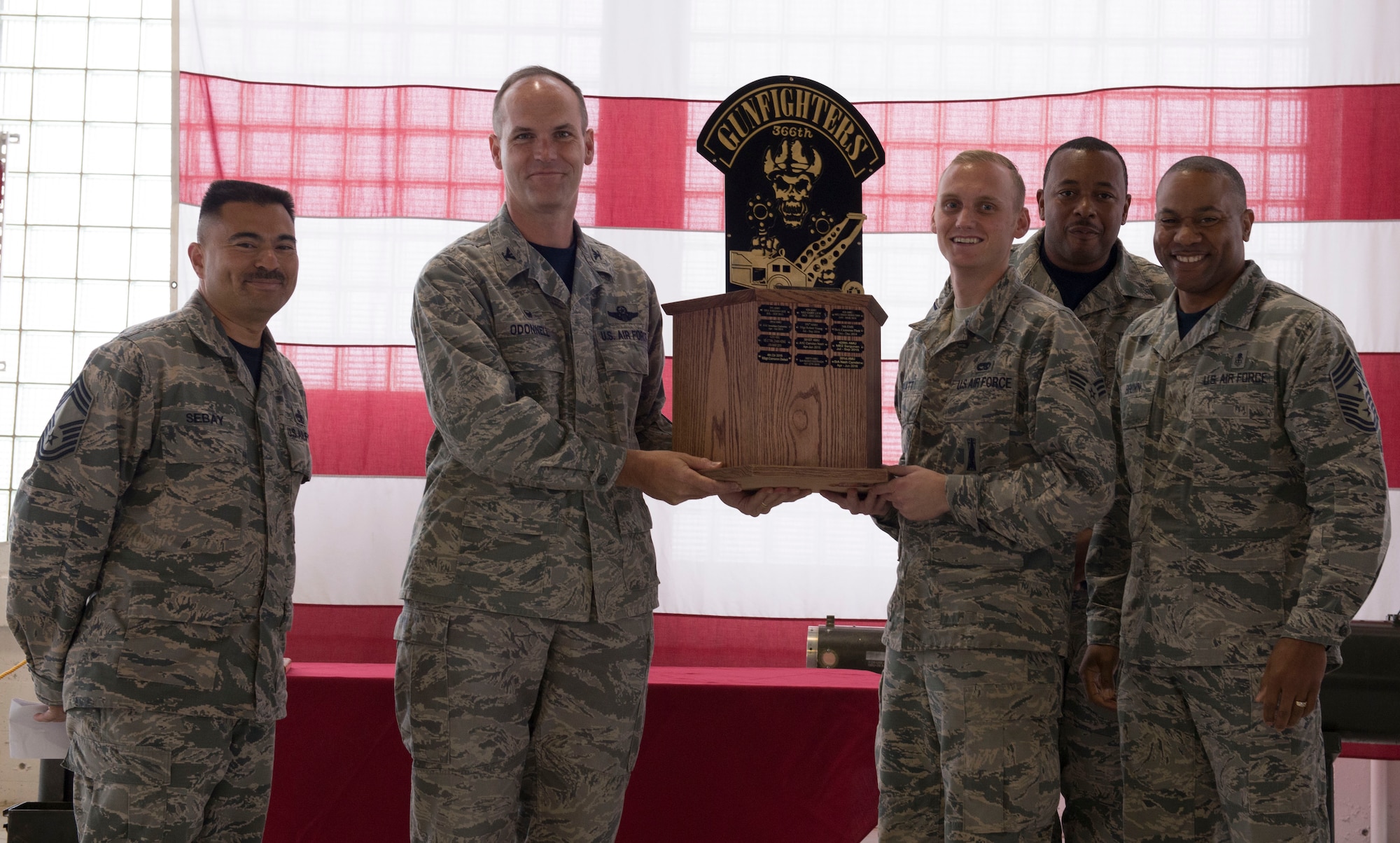 366th Fighter Wing commander Col. Jefferson O'Donnell presents Senior Airman Cameron Platt, 366th Equipment Maintenance Squadron armament cast member, with the 1st place trophy for the munitions lift truck maneuverability competition Oct. 14, 2016, at Mountain Home Air Force Base, Idaho. The course included weaving between cones, dropping a skeleton into a bucket and smashing pumpkins. 