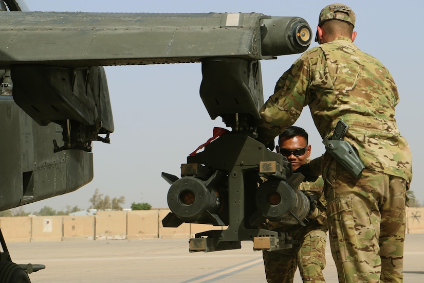 Army Pfc. Jazel Yadao and Sgt. Sean Parker slide a Hellfire missile into place on an AH-64 Apache attack helicopter at Taji Airbase, Iraq, Sep. 22, 2016. The soldiers are assigned to 1st Attack Reconnaissance Battalion, 10th Aviation Regiment, Apache helicopters are supporting the night operations of Iraqi forces as they seek to retake Mosul. Army photo by Sgt. 1st Class R.W. Lemmons IV