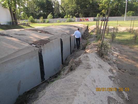 Pictured is a segment of the precast concrete arch culvert the Corps constructed as part of the flood risk management project in Cincinnati. The joints between the sections have separated and the alignment has shifted. Erosion is also present at right.
