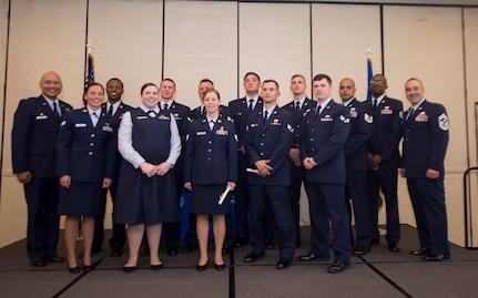 Col. Jimmy Canlas, 437th Airlift Wing commander (far left), and Chief Master Sgt. Kristopher Berg (far right), 437th AW command chief, pose for a group photo with 437th AW Airmen during the fall graduation ceremony for the Community College of the Air Force here Oct. 13, 2016. The CCAF is a federally-chartered, degree-granting institution serving the United States Air Force's enlisted total force.
