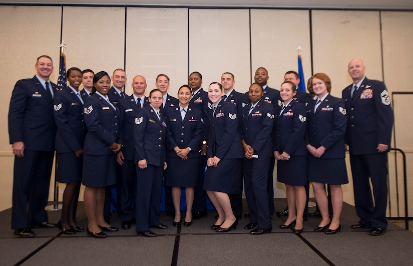 Col. Robert Lyman, 628th Air Base Wing commander (far left), and Chief Master Sgt. Todd Cole (far right), 628th Air Base Wing command chief, pose with 628th ABW Airmen during the fall graduation ceremony for the Community College of the Air Force here Oct. 13, 2016. The CCAF is a federally-chartered, degree-granting institution serving the United States Air Force's enlisted total force.