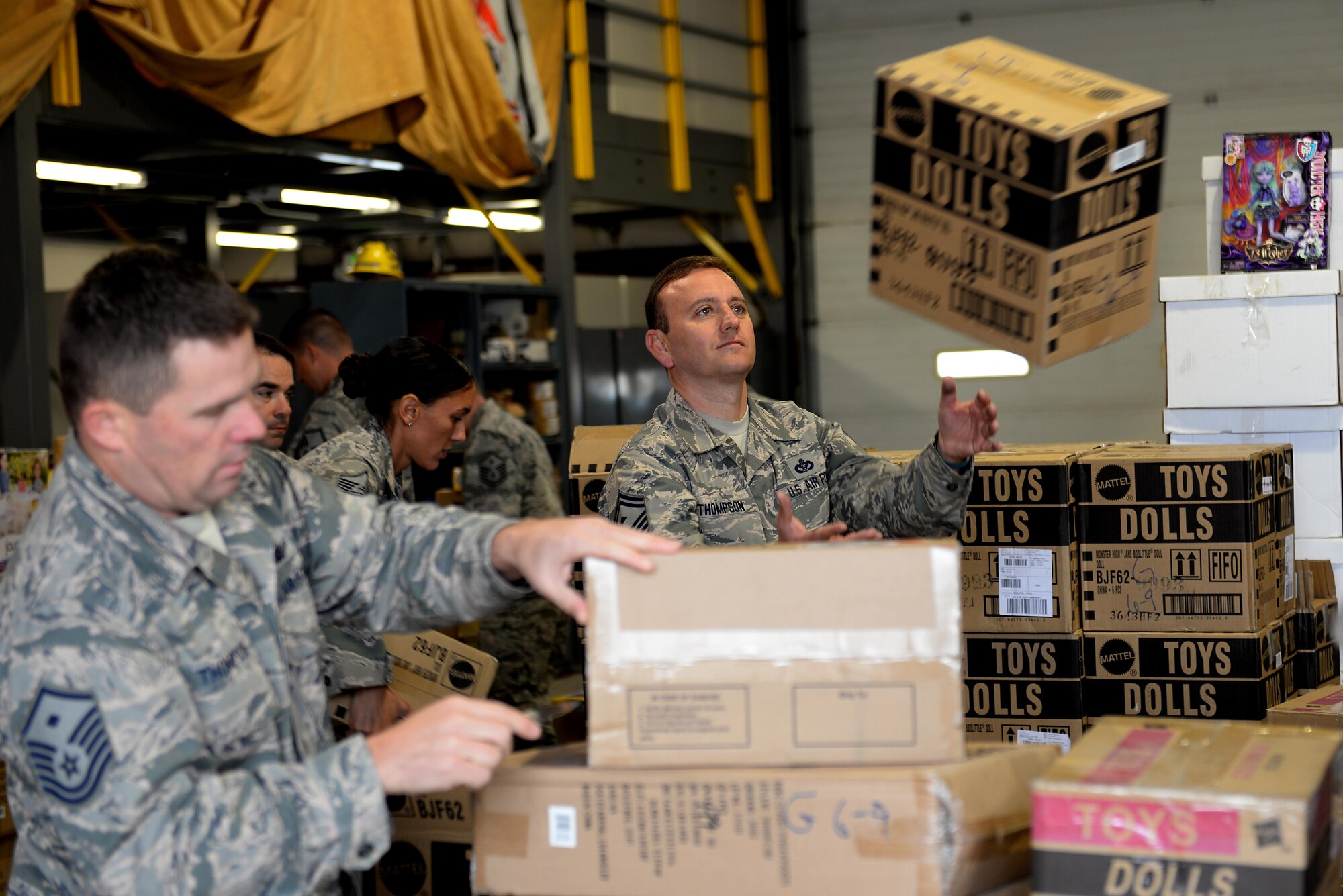Senior Master Sgt. Stephen Thompson, the 835th Cyberspace Operations Squadron First Sergeant, catches a box of toy dolls at the Civil Engineering Squadron Compound, Scott Air Force Base, Ill. Oct. 13, 2016. The First Sergeants Council received a donation of 27,000 toys from H.E.R.O.E.S. Care for the First Sergeants to distribute to their Airmen and their familiy members for Christmas. (U.S. Air Force Photo by Senior Airman Megan Friedl)